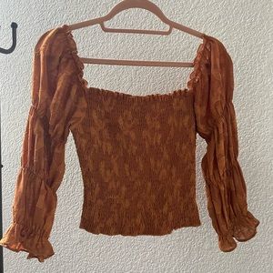 Dark orange/ gold smocked crop top from Lulu’s